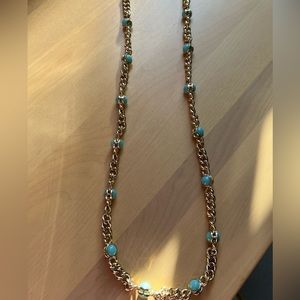 Gold costume jewelry chain with robin egg colour blue stones.